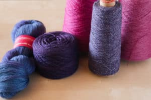 Yarn in a variety of formats — skeins, cakes, balls, cones