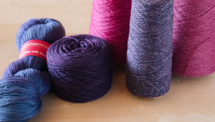 Yarn in a variety of formats — skeins, cakes, balls, cones
