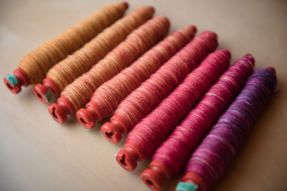 SweetGeorgia Sock Blank in Wanderlust, wound onto a series of weaving pirns