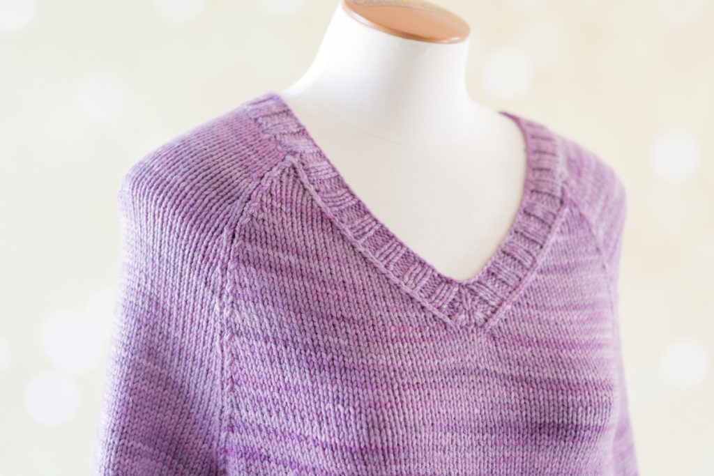 Flannery, a raglan sweater knit in SweetGeorgia Superwash Worsted in Lilac colourway