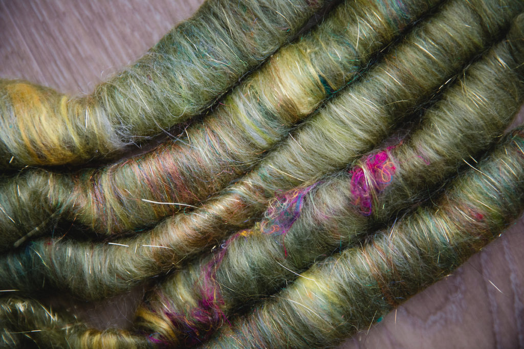 Spinning fibre rolags by Debbie Held