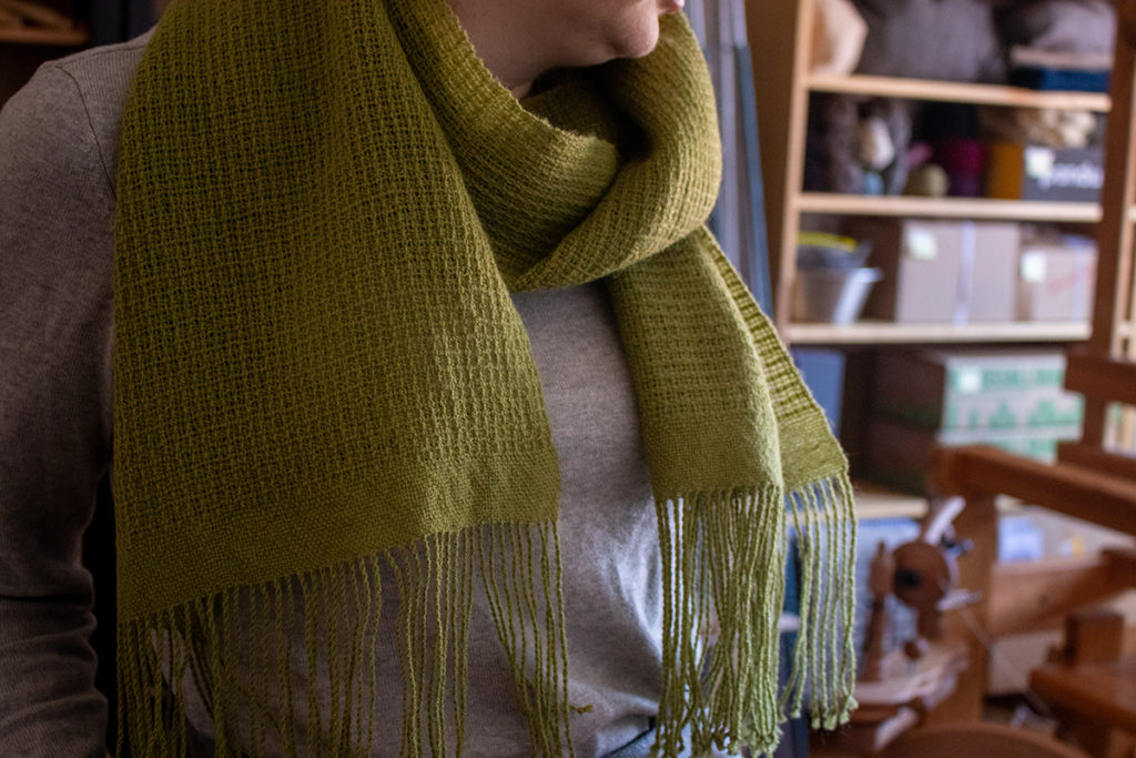Image of a green woven scarf that is Good Cloth to me.