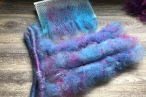 purple and blue fiber on a carder in article: Fibre Processing at Home: Which Blending Tool(s) Should I Buy First? Debbie Held