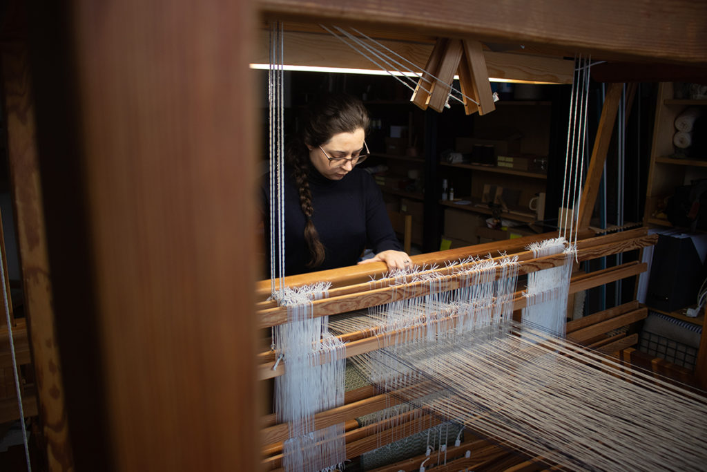 Amanda weaving on a large Glimåkra loom